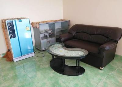 Compact living room with leather sofa and glass coffee table