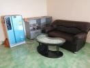 Compact living room with leather sofa and glass coffee table