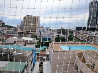 Urban view from high-rise balcony featuring cityscape and pool