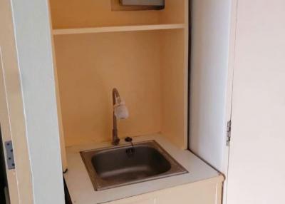 Compact utility area with sink and storage space