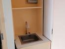 Compact utility area with sink and storage space