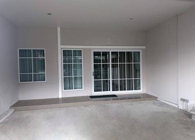 Empty interior space of a building with large windows and tiled flooring