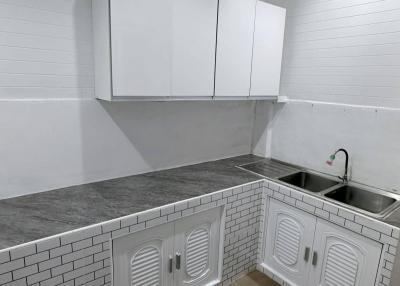 Modern kitchen with white cabinetry and subway tiles