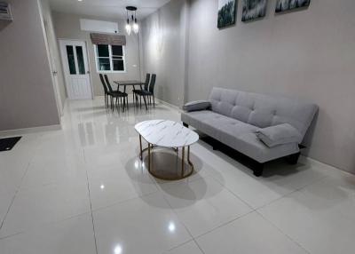 Spacious and modern living room with dining area in the background