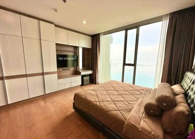 Spacious bedroom with modern built-in kitchenette and large window
