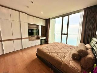 Spacious bedroom with modern built-in kitchenette and large window
