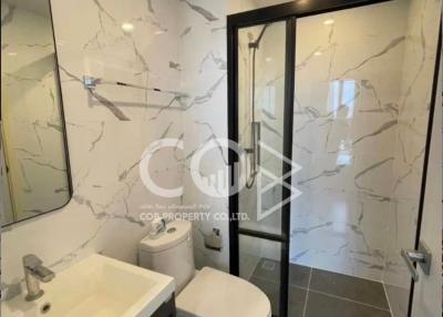 Modern bathroom with marble tiles and glass shower door