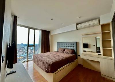 Modern bedroom with city view and ample daylight