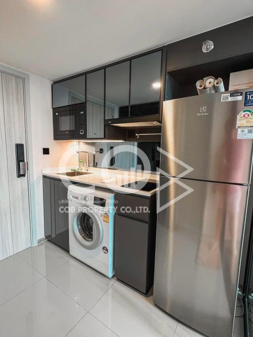 Modern kitchen with stainless steel appliances and black cabinetry