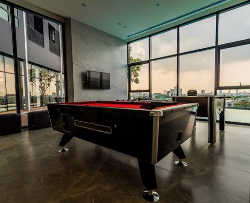 Spacious recreation room with pool table and modern design