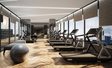 Modern gym interior with multiple treadmills and panoramic city views