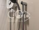 Modern wall-mounted electric shower unit with adjustable shower head in a tiled bathroom