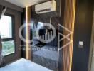 Modern bedroom interior with marble wall and mounted air conditioning unit