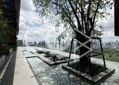 Spacious outdoor terrace with city skyline view and lush tree