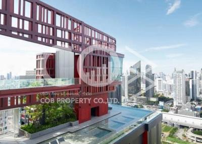 Modern building exterior with distinctive red design features overlooking the city