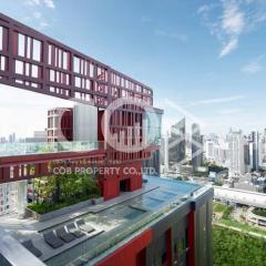 Modern building exterior with distinctive red design features overlooking the city