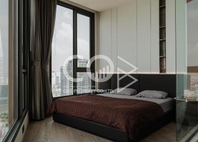Modern bedroom with large window offering city view