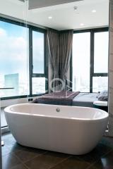 Modern bathroom with freestanding bathtub and floor-to-ceiling windows