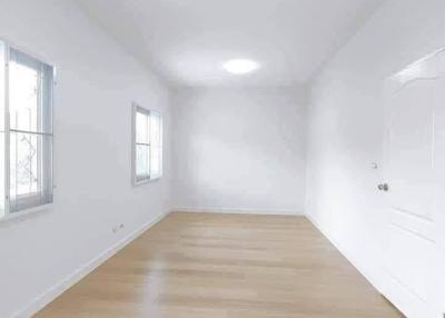 Spacious and Bright Empty Bedroom with Hardwood Floors