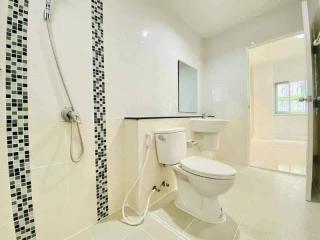 Modern bathroom with black and white tiles and natural light