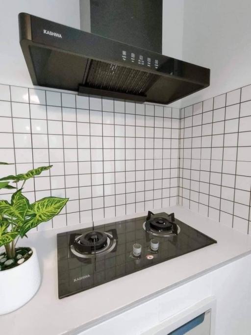 Modern kitchen with clean white tile backsplash and stainless steel range hood