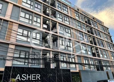 Exterior view of a modern multi-story apartment building at dusk