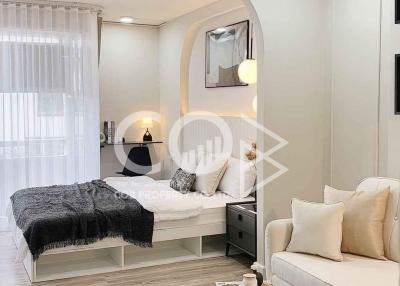 Modern bedroom with comfy bed, stylish decor, and ample lighting