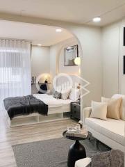 Modern bedroom with comfy bed, stylish decor, and ample lighting