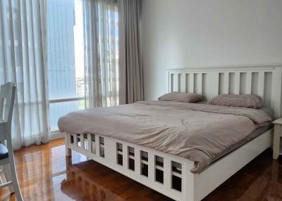 Spacious bedroom with king-size bed and floor-to-ceiling windows