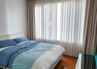 Cozy bedroom with large bed and natural light