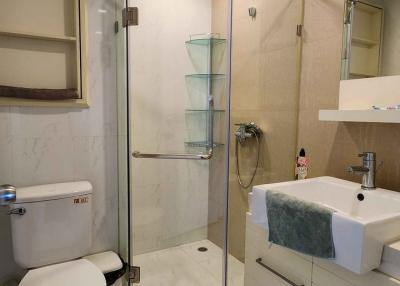 Modern bathroom with glass shower and marble tiles