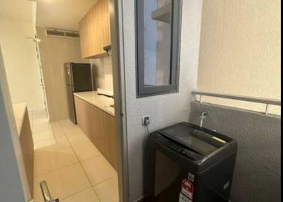 Compact kitchen with modern appliances and tiled flooring