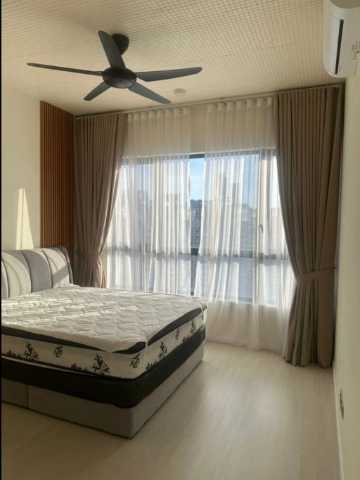 Modern bedroom with natural lighting and ceiling fan