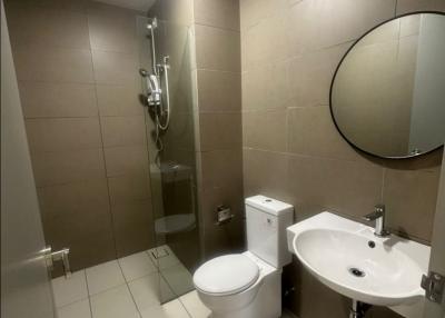 Modern bathroom with neutral color tiles and sleek fixtures