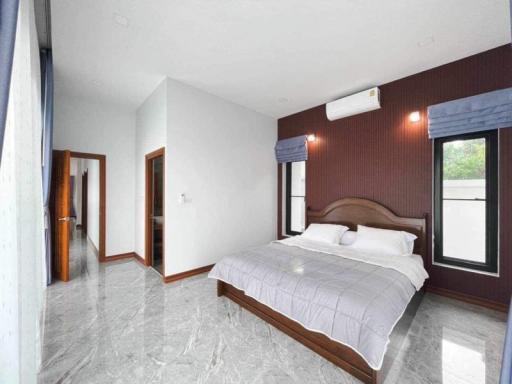 Spacious bedroom with polished marble floor and modern air conditioning