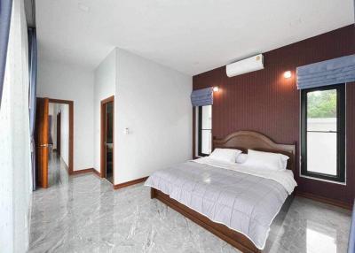 Spacious bedroom with polished marble floor and modern air conditioning