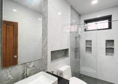 Modern bathroom with marble tiles and black countertop
