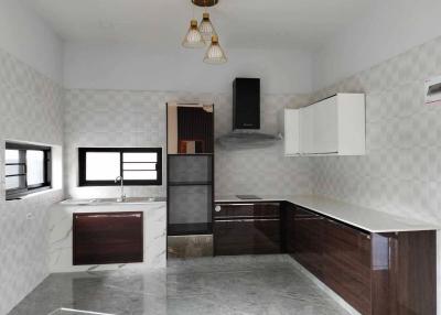 Modern kitchen with marble flooring and dark wood cabinets