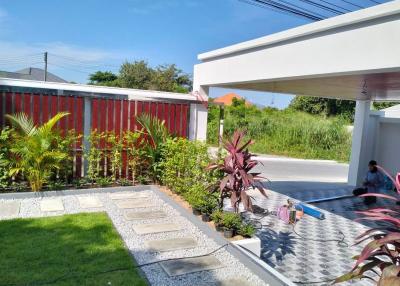 Modern home exterior with landscaped garden and spacious driveway