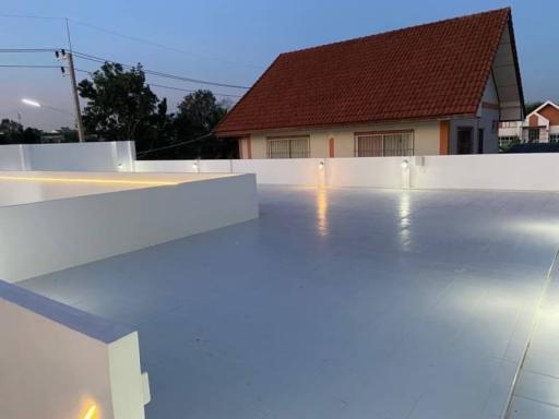 Exterior view of a standalone residential house at dusk with lighting