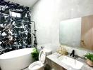 Modern bathroom with a freestanding tub, stylish mirror, and elegant countertops