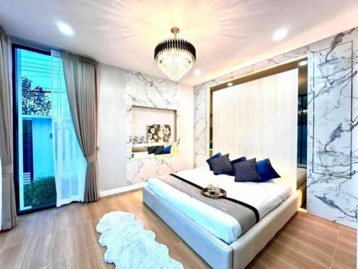 Elegant bedroom with marble walls, large bed, and stylish decor