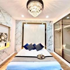 Elegant bedroom with marble wall design and modern chandelier