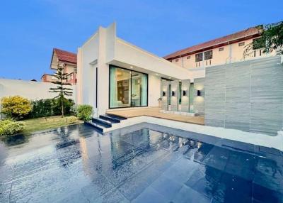 Modern house with exterior view showcasing the pool and patio area during twilight