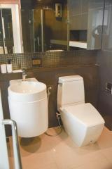 Modern bathroom with ceramic fixtures and tiled walls