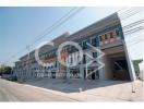 Exterior view of a modern commercial building with parking space