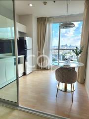 Modern kitchen with cityscape view through floor-to-ceiling windows