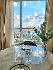 Cozy living room with a scenic city view through large windows