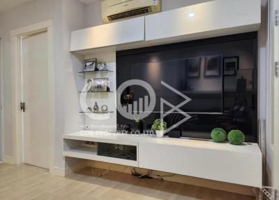 Modern living room with wall-mounted television and shelving unit
