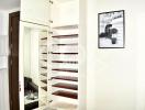 Modern white closet with open shelves in a tidy room